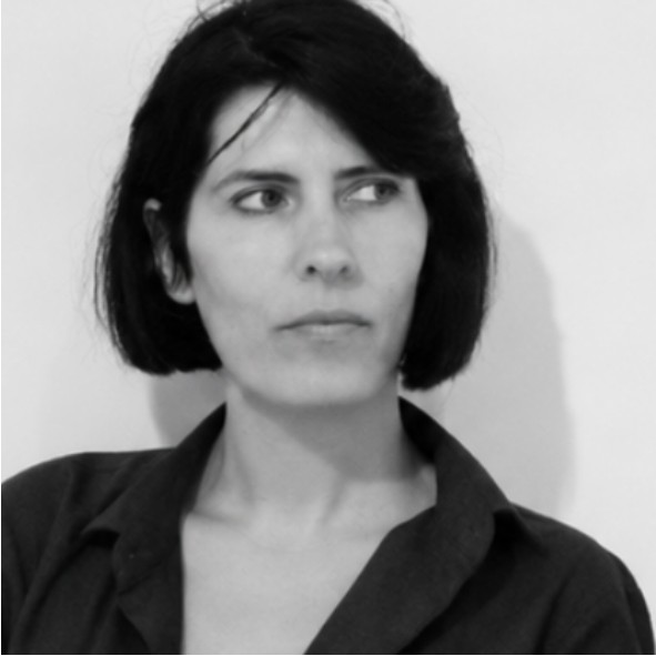 Black and white photo of a person with short dark hair, wearing a collared shirt, looking slightly to the side with a neutral expression against a plain light background.